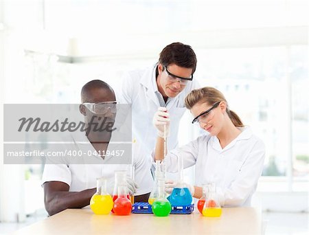 Scientists examining test-tubes in a laboratory