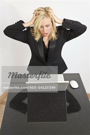 A stunningly beautiful young woman having problems with her laptop computer