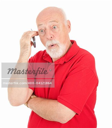 Surprised senior man talking on his cell phone.  Isolated on white.