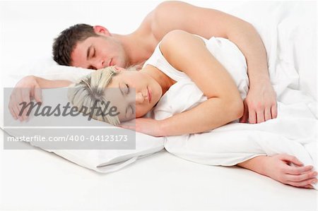 Blonde young girl sleeping with a boy in bed