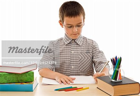 Schoolboy doing his homework - isolated