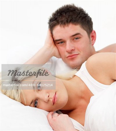 Portrait of a couple lying together in bed