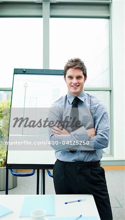 Young caucasian businessman explaining at the whiteboard