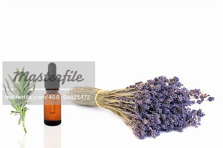 Lavender dried herb flowers and essential oil glass dropper bottle with leaf sprig, over white background.