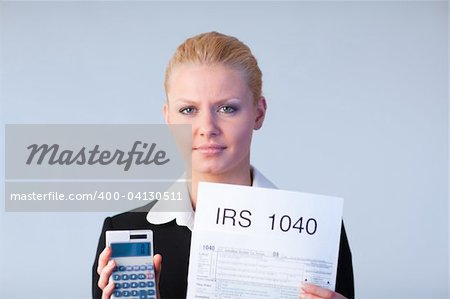 Business woman looking at filling in tax returns