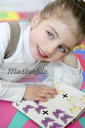 Beautiful preschooler little girl sutdent learning with homework book