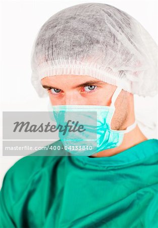 Portrait of a young surgeon with mask and hat on