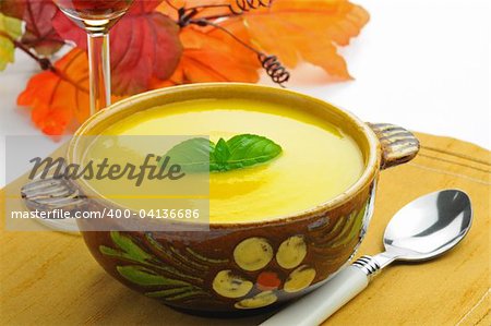 Yellow autumn squash and corn soup in a bowl.