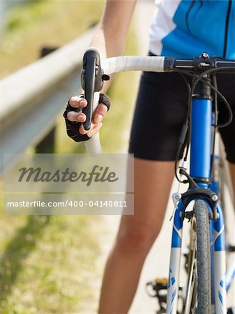 Cropped view of female cyclist with hands on brakes. Copy space