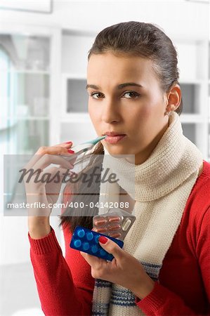 Closeup portrait of cute brunette woman checking her body temperature