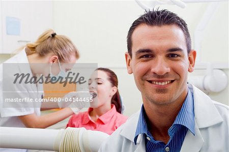 friendly male dentist in his practice