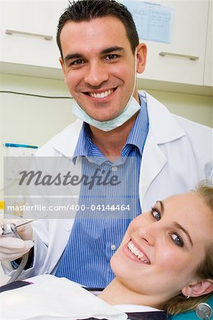 happy dentist and patient in dentist's office