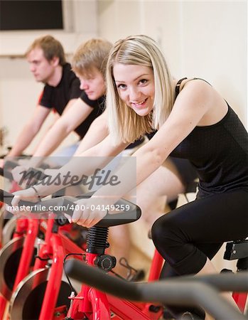 Group of people having spinning class with a girl in focus