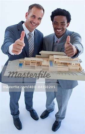 High view of architects holding a model house with thumbs up