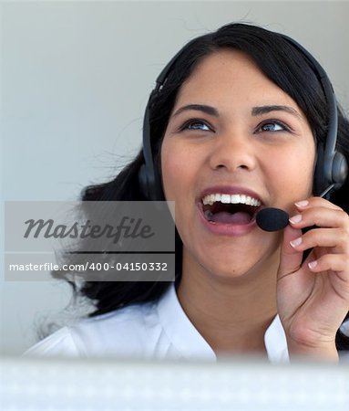 Beautiful businesswoman talking on a headset in a call center