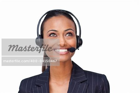 Portrait of a beautiful ethnic businesswoman with a headset on looking upwards