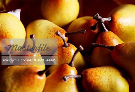 Several yellow pears on a wooden surface