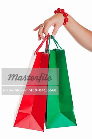 Christmas shopper with red and green shopping bags.  Shot on white background.