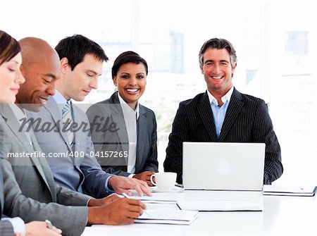 Attractive female executive looking at her team