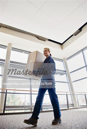 Young woman delivering boxes.  Vertically framed shot.