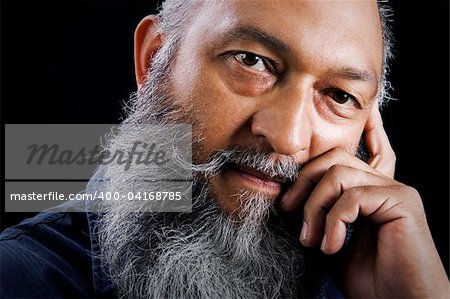 Stock image portrait of Man with long beard over dark background