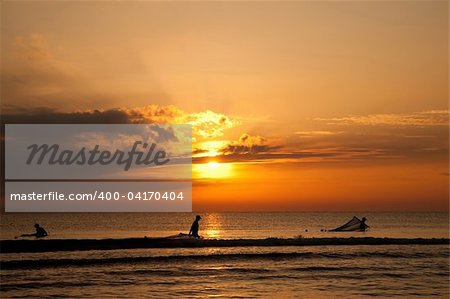 Silhouettes Of Fishermen  On The Sunrise Background