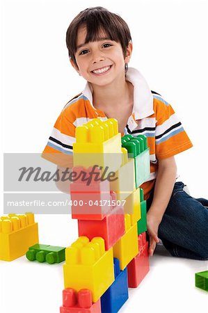 Young boy playing with building blocks on white background