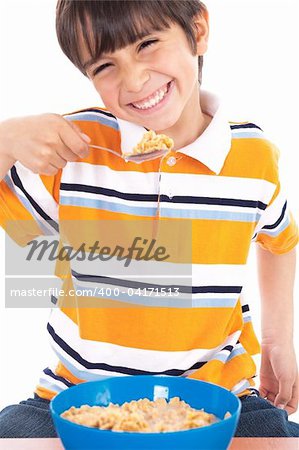 Young boy eating his breakfast on isolated white background