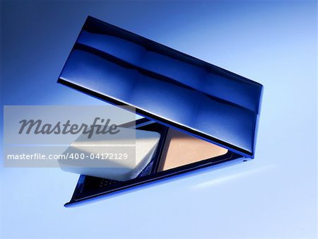 cosmetic powder on the blue background