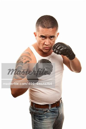 Hispanic man doing mixed martial arts wearing gloves