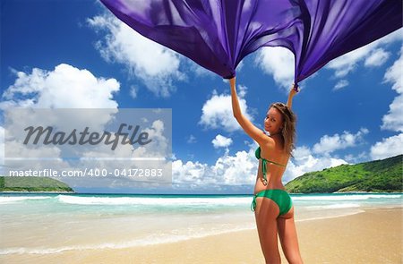 Woman with sarong on beautiful beach