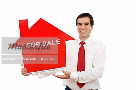 Real estate agent holding house shaped for sale sign