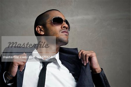 Man looks up as he holds his suit jacket