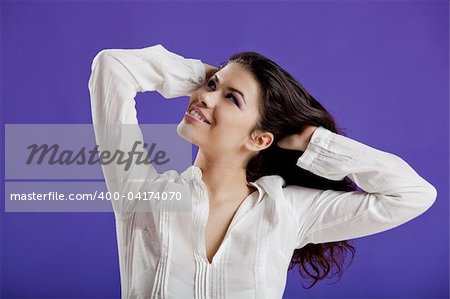 Studio portrait of a young beautiful woman posing on a purple background