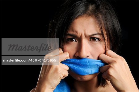 Girl gagged with blue scarf pulls to free her voice
