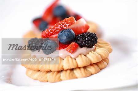 Delicious cookies with chocolate cream and fresh berries
