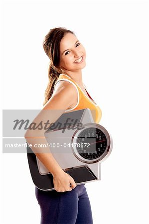 Portrait of a beautiful athletic girl holding a scale, isolated on white