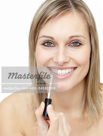 Smiling woman putting gloss against a white background