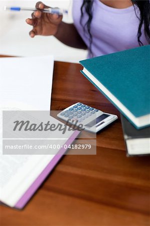 Close-up of a student doing her homework at home