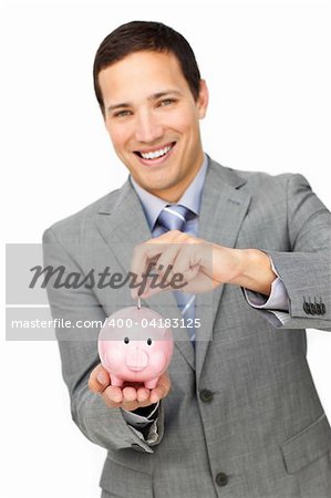 Cheerful businessman saving money in a piggy-bank against a white background