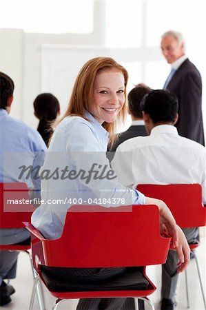 Attractive businesswoman smiling at the camera at a conference