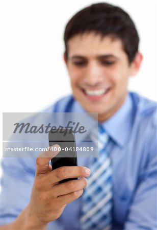 Smiling businessman sending a text against a white background