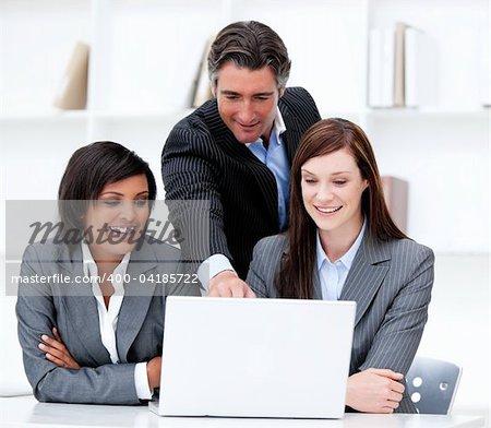 Multi-ethnic business team working at a computer in the office