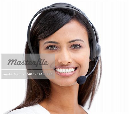 Portrait of a beautiful ethnic businesswoman with a headset on smiling at the camera