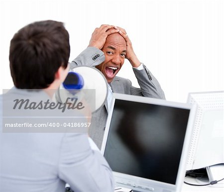 Stressed businessman yelling through a megaphone in the office