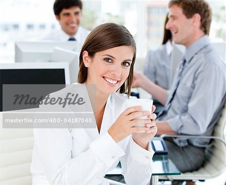 Smiling businesswoman holding a cup of tea in the office