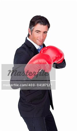 Portrait of a confident businessman wearing boxing gloves isolated on a white background