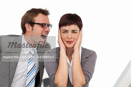 Stressed businessman shouting into his colleague's ear in the office