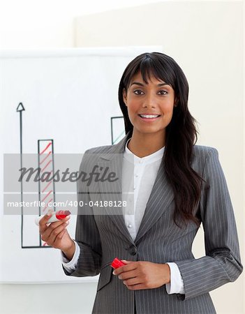 Ethnic young businesswoman reporting sales figures isolated on a white background