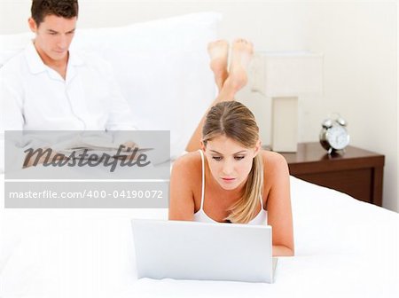 Adorable couple surfing on the internet at home